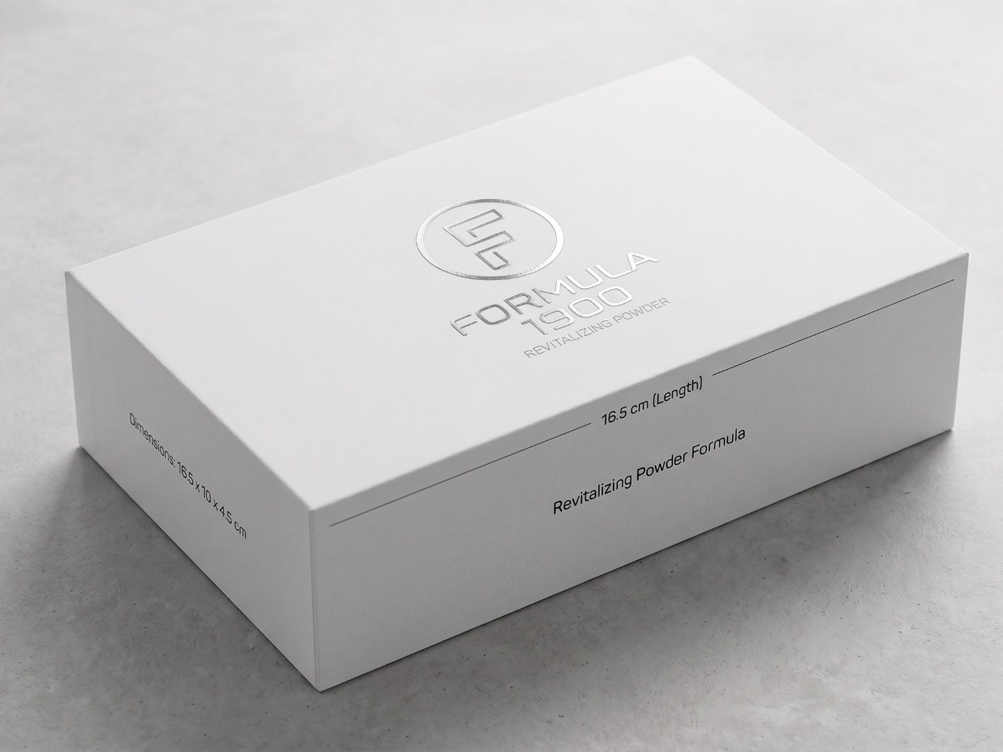 The Formula 1900 outer box — a white rigid presentation box with a silver foil-stamped monogram.